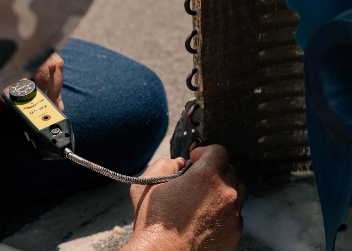 Technician servicing the internal coil of an air conditioning unit