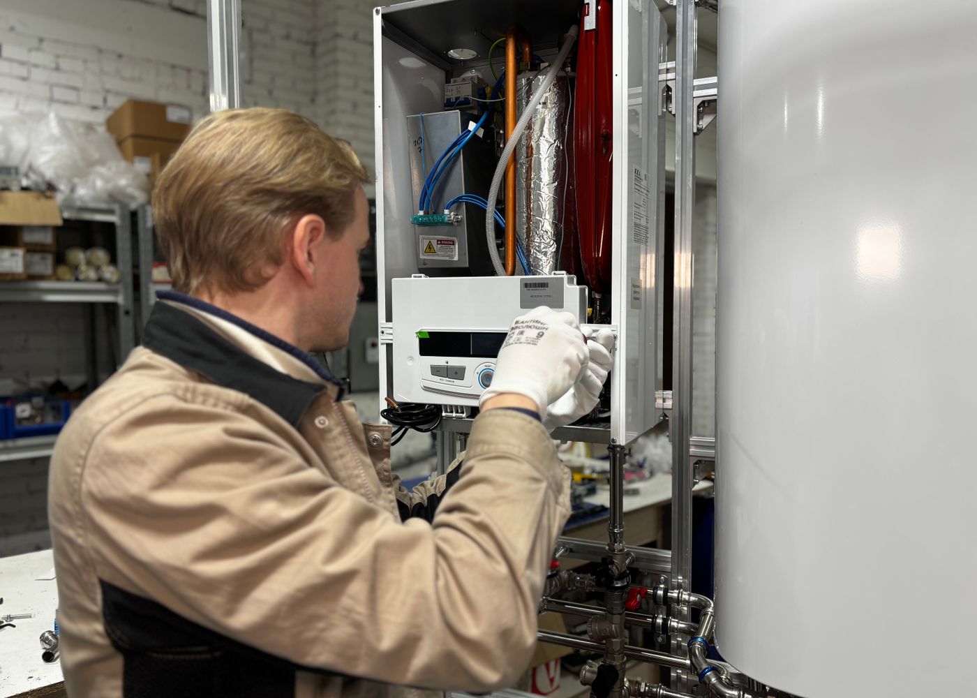 Technician inspecting controls inside a heating system
