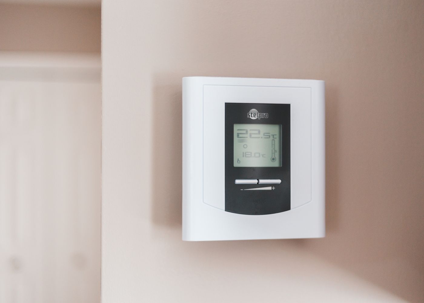 Wall-mounted digital thermostat in a home